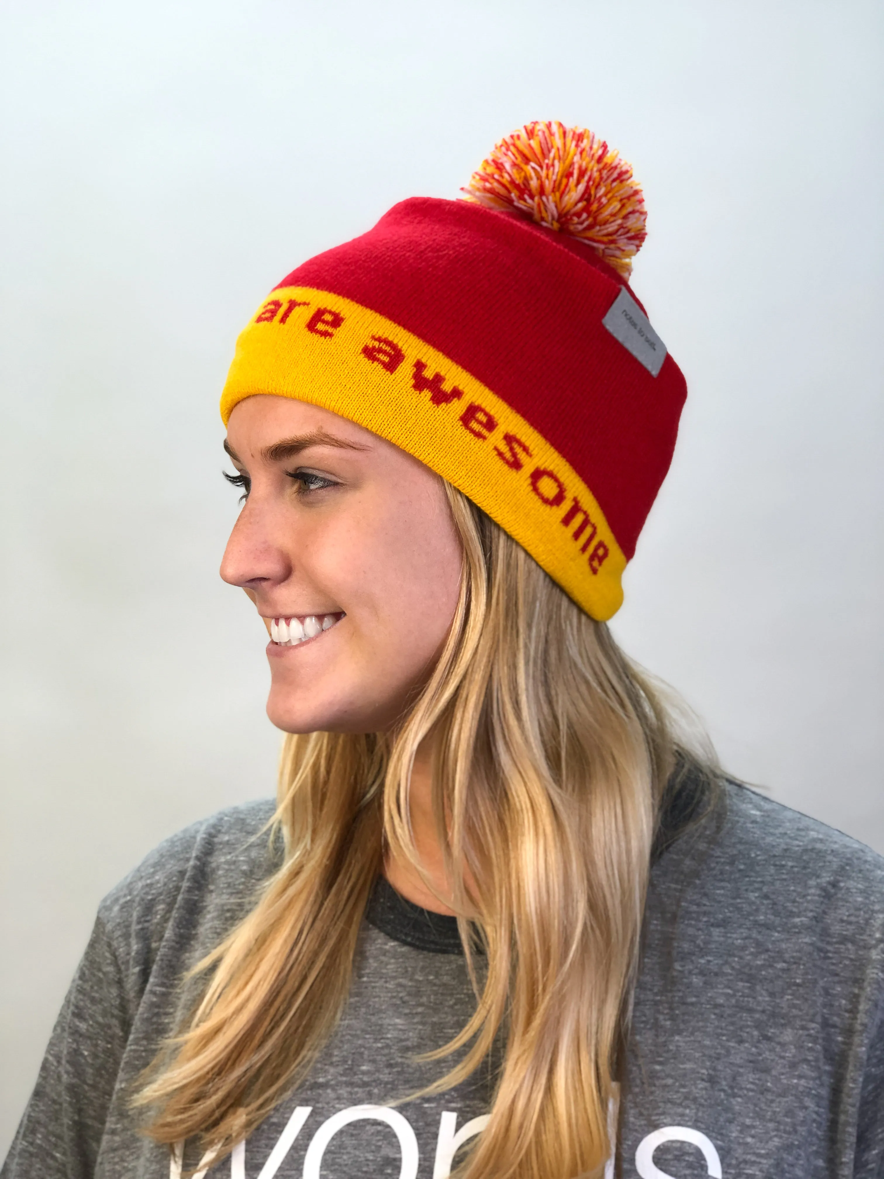 I believe™ red & gold knit beanie with We are awesome™ on inside cuff